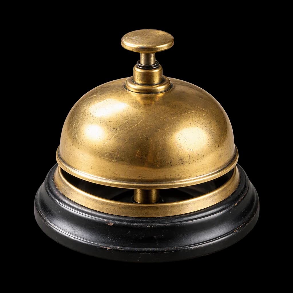 A brass reception desk bell