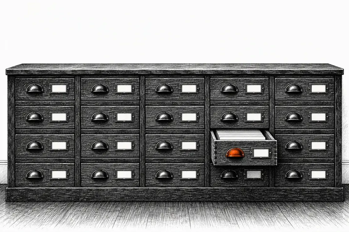 Engraving of a long bank of shallow workshop drawers, one pulled open on a stack of blank cards