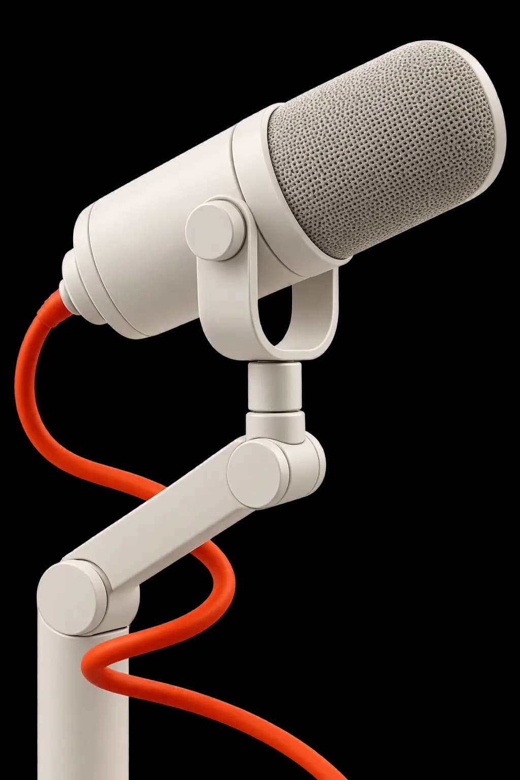 An off-white broadcast microphone on a desk arm with a coiled orange cable